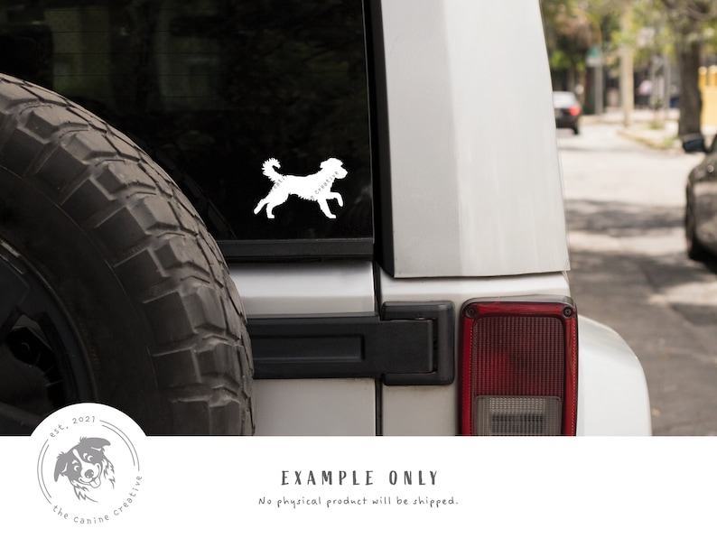 May include: White silhouette of a dog running on a silver car. The car has a black tire and a red taillight. The text "est. 2021 the canine creative" is in a circle on the lower left corner of the image.