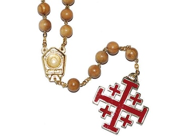 May include: A wooden rosary with a gold-colored metal crucifix. The crucifix is a red Jerusalem cross with five smaller crosses. The rosary beads are brown and the chain is gold-colored.