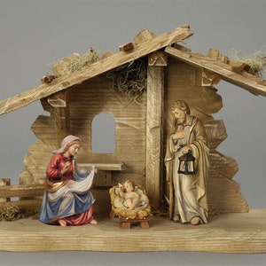 Wooden nativity scene of the Holy Family with a hut entirely made of wood, created in Val Gardena