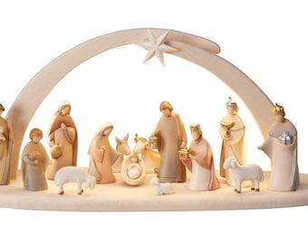 May include: A wooden nativity scene with a star on top and a lit-up archway. The scene includes figures of Mary, Joseph, baby Jesus, the three wise men, shepherds, and animals.