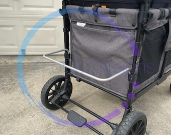 May include: A gray and black wagon with a black fabric seat and a gray fabric storage compartment. The wagon has a silver handle and a foot brake. The wagon is on a gray concrete surface.