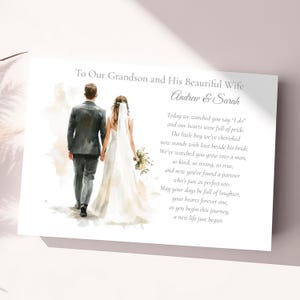 May include: A wedding card with a watercolor illustration of a couple walking away, holding hands. The text reads "To Our Grandson and His Beautiful Wife" and includes a poem. The couple is dressed in wedding attire.