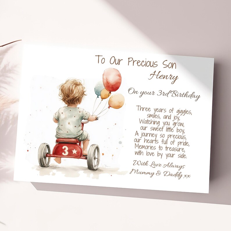 May include: A watercolor illustration of a child riding a red tricycle with a star and the number 3 on the side. The child is holding balloons in their hand. The illustration is on a white card with a poem about a child's 3rd birthday. The poem reads "To Our Precious Son Henry On your 3rd Birthday Three years of giggles, smiles, and joy. Watching you grow, our sweet little boy, A journey so precious, our hearts full of pride, Memories to treasure, with love by your side. With Love Always Mummy & Daddy xx"