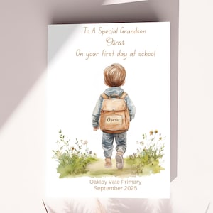 May include: A watercolour card featuring a young boy with a backpack walking on a path, with the text "To A Special Grandson Oscar On your first day at school." The card also includes the text "Oakley Vale Primary September 2025."