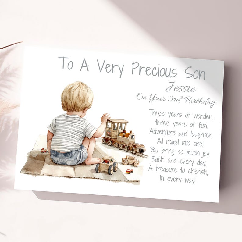 May include: A greeting card with a watercolor illustration of a young child playing with toy cars and a train. The text reads "To A Very Precious Son Jessie On Your 3rd Birthday" with a poem. The card is white with a soft, blurred background.