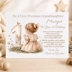 May include: A white birthday card for a granddaughter named Margot, featuring a large number one, a small girl in a floral dress, and a poem. The text reads: To A Very Precious Granddaughter, Margot, On Your 1st Birthday, followed by a poem and With Love Nannie and Granddad.