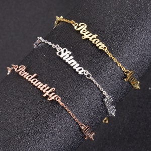 May include: Three nameplate bracelets in gold, silver and rose gold with the names "Peyton", "Shuma" and "Vendanutilyo" on them.