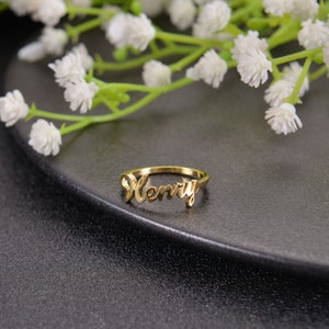 May include: Gold ring with the name "Henry" written in cursive.