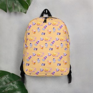 Mochila escolar para niños Space Explorer: astronauta de dibujos animados y patrones de cohetes en rosa y amarillo juguetones