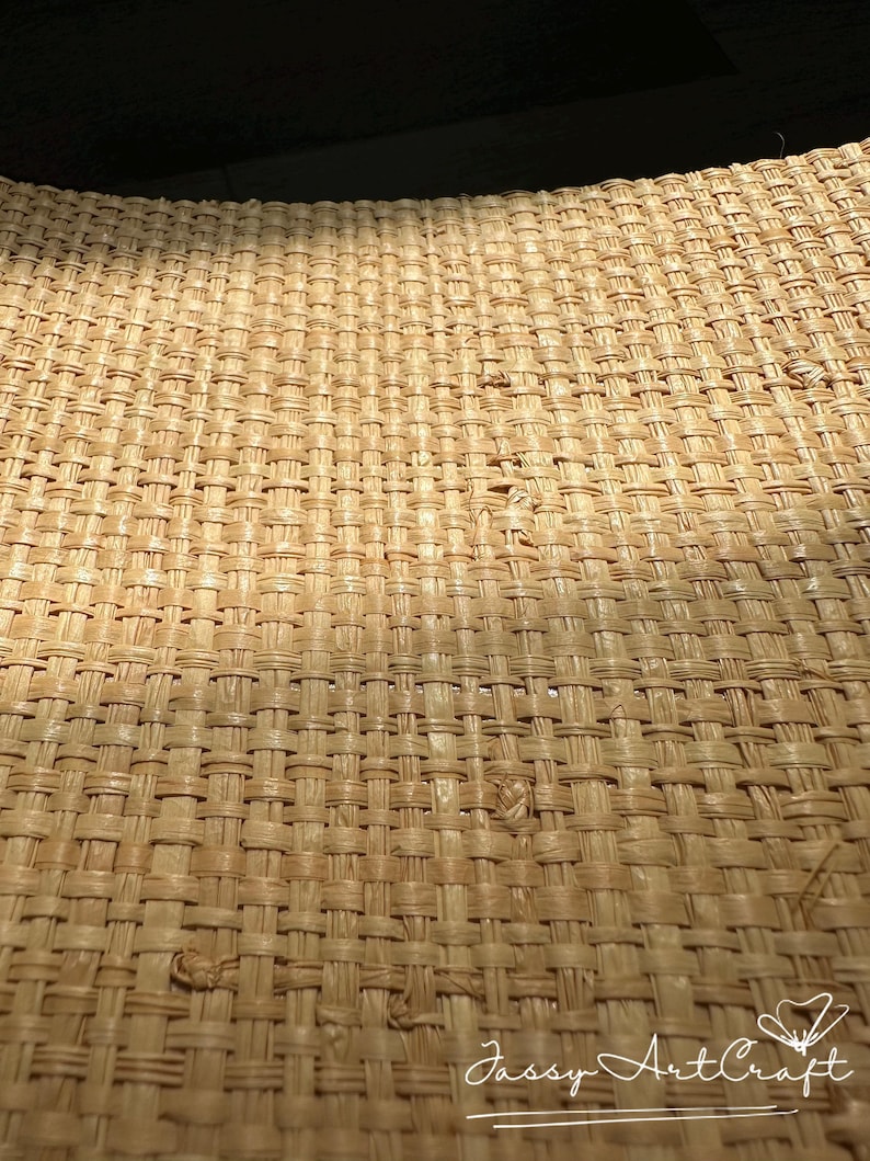 May include: Close-up of a woven wicker surface, showcasing a detailed pattern of interwoven strands in a natural beige hue. The texture is rough and organic, with subtle variations in color and weave density. The image is well-lit, highlighting the craftsmanship.