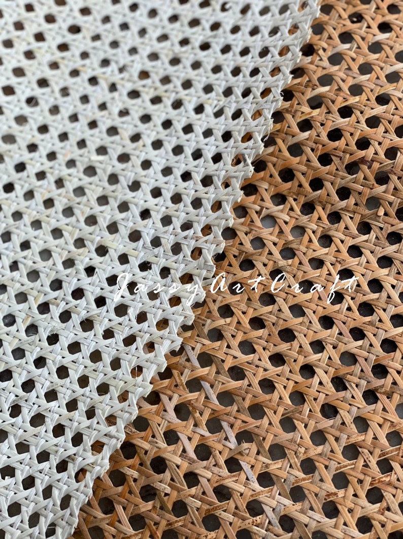 May include: Close-up of two woven cane panels, one white and one natural brown. The panels are made of thin strips of cane woven together in a diamond pattern. The white panel is on top of the brown panel.