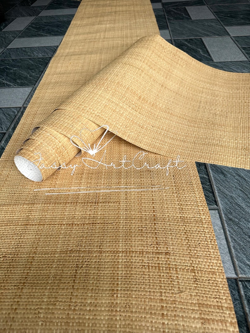May include: A roll of natural-colored woven material, partially unrolled, revealing a textured surface. The material appears to be made of woven fibers, possibly for use as a decorative element or craft supply. The text "Sassy Art Craft" is visible.