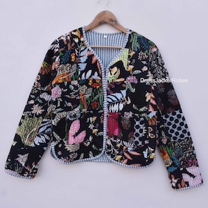 May include: A black quilted jacket with a floral print. The jacket has a V-neck and a button closure. The fabric is a patchwork of different floral patterns in shades of pink, blue, green, and yellow.