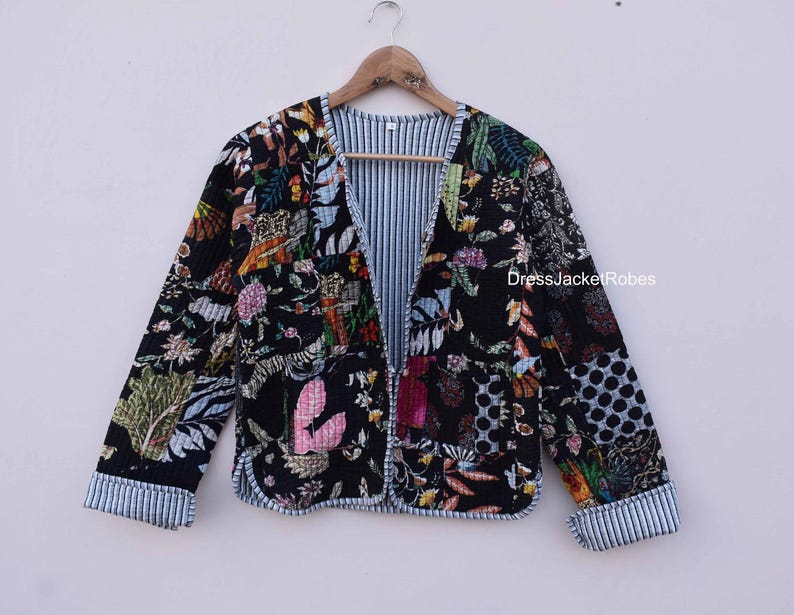May include: A black quilted jacket with a floral print and a striped lining. The jacket has a button closure and long sleeves.