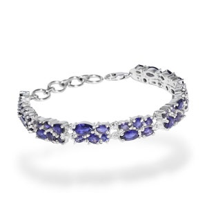 May include: A silver bracelet featuring two rows of oval-shaped, deep blue gemstones. The bracelet has a delicate chain and clasp closure. The gemstones are set closely together, creating a continuous band of color. The jewelry is displayed against a white background.