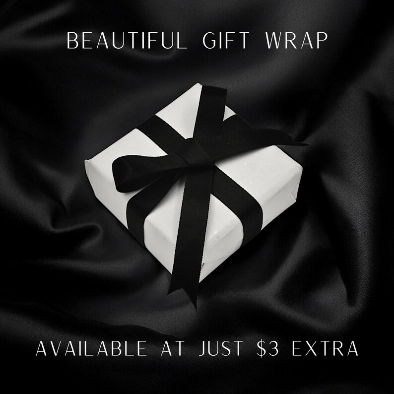 May include: A white gift box with a black ribbon tied in a bow. The text "BEAUTIFUL GIFT WRAP" is at the top of the image and the text "AVAILABLE AT JUST &pound;3 EXTRA" is at the bottom of the image.