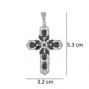 May include: A silver cross pendant with black gemstone accents. The cross measures 3.2 cm wide and 5.3 cm tall.