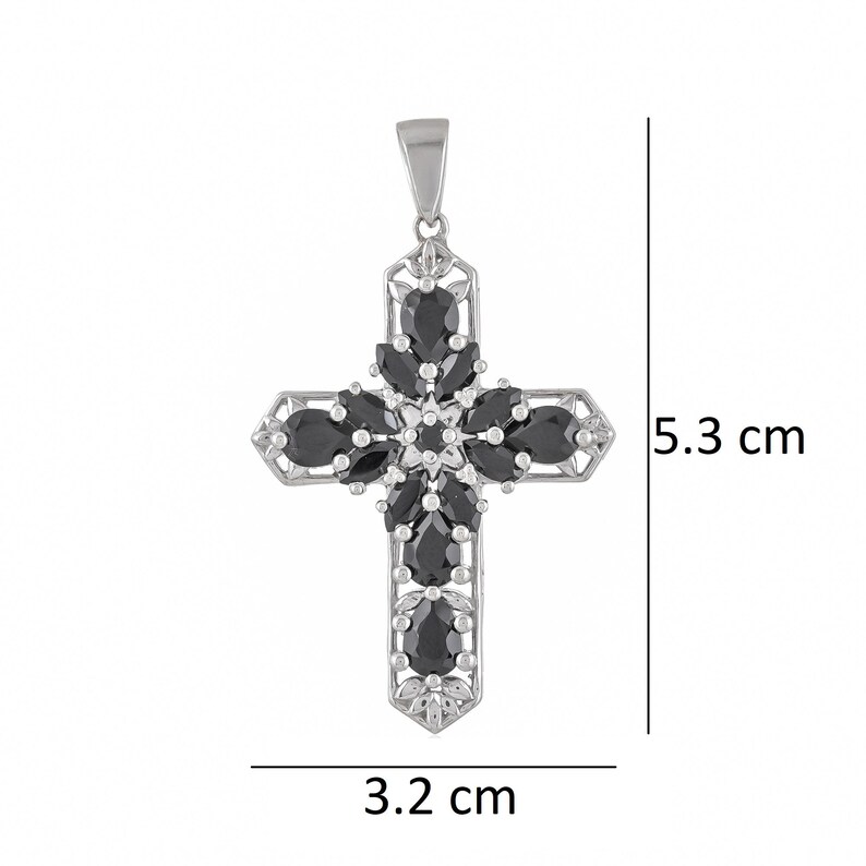 May include: A silver cross pendant with black gemstone accents. The cross measures 3.2 cm wide and 5.3 cm tall.