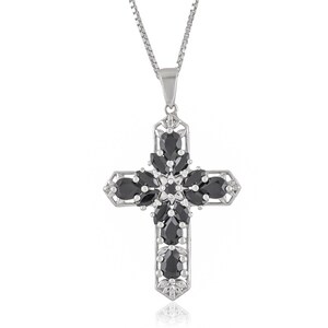 May include: A silver cross pendant necklace with black gemstones. The cross is adorned with a floral design and features a delicate chain.