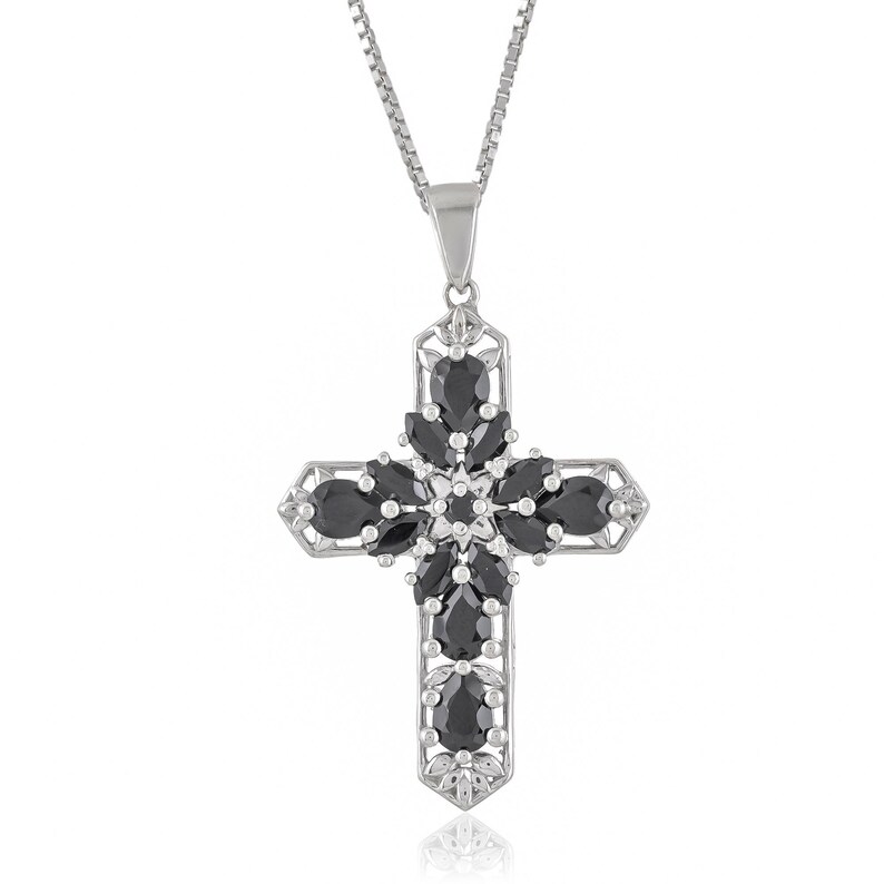 May include: A silver cross pendant necklace with black gemstones. The cross is adorned with a floral design and features a delicate chain.