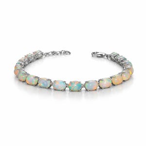 May include: A silver-toned bracelet featuring a series of oval-shaped, iridescent opals set in metal prongs. The bracelet is connected by small circular links and includes a lobster claw clasp closure, showcasing a play of light across the stones.