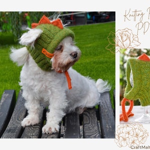 May include: A white dog wearing a green and orange knitted dinosaur hat. The hat has orange spikes and a small orange strap. The image also includes a smaller image of the hat on a glass and the text "Knitting Pattern PDF".