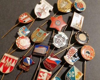 Old, vintage metal stick pins. The pins are all made of metal and often have beautiful images of cities or buildings.