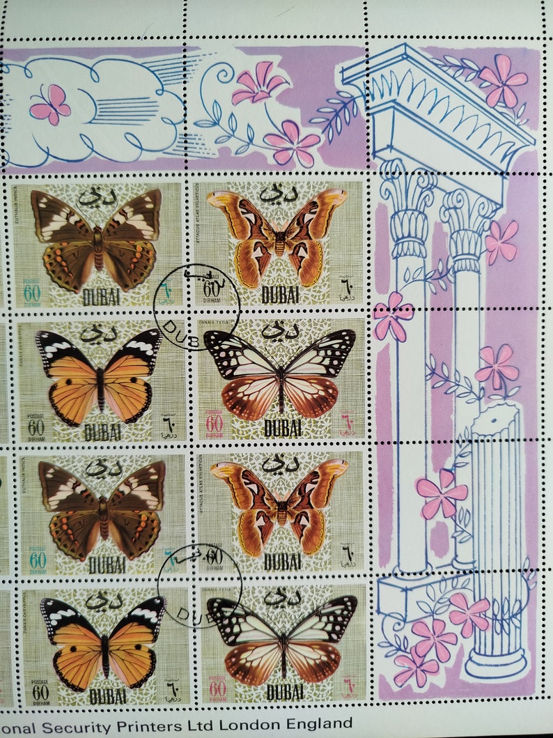 May include: Sheet of postage stamps from Dubai featuring colorful butterfly illustrations. The stamps have a light green background with the word "DUBAI" and the value "60" printed on them. Decorative floral and architectural elements are also present.