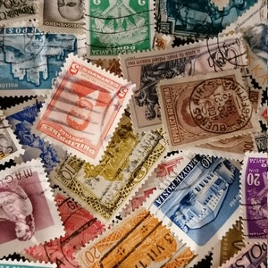 May include: A collection of vintage postage stamps from various countries, including the Philippines, Argentina, Poland, and Yugoslavia. The stamps feature a variety of designs, including buildings, flags, and portraits. Some of the stamps are in color, while others are in black and white.