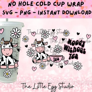 May include: A pink and white cold cup wrap design featuring a cartoon cow holding a cup of tea. The text "Moody Without Tea" is written in black letters on a white background. The design also includes daisies and hearts.