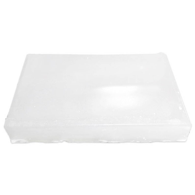 May include: A rectangular block of white wax, likely for candle making or other crafts. The wax has a slightly uneven surface and a solid, opaque appearance. The block is shown against a plain white background.