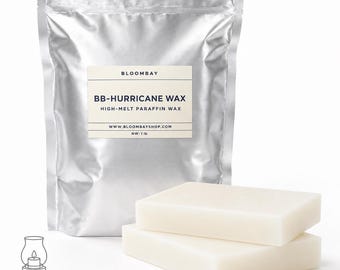 May include: A silver bag of BB-Hurricane wax with a label that reads "BB-HURRICANE WAX HIGH-MELT PARAFFIN WAX". Two rectangular wax blocks are in front of the bag. The net weight is 1 lb. The image also includes a candle shell graphic.
