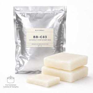 Op de afbeelding: Een zilveren zak met BLOOMBAY BB-C83 kokoscontainerwas, met drie rechthoekige blokken was ervoor. Het label luidt "For Container Candles & Tealights" en "NW: 1 lb".