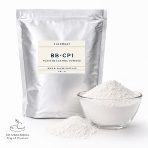 May include: A silver bag of BB-CP1 Plaster Casting Powder, with a clear glass bowl and a small pile of white powder. The bag has a label with the brand name and website. The net weight is 1 lb. Text at the bottom says "For Aroma Stones, Trays & Coasters."