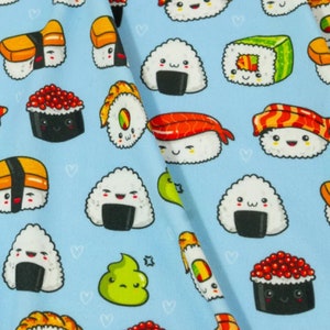 May include: A blue fabric with a repeating pattern of various types of sushi, including maki, nigiri, and onigiri. The sushi is illustrated in a cartoon style with smiling faces.