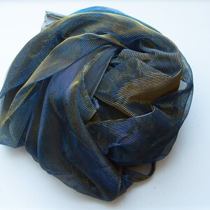 May include: A blue and gold metallic mesh fabric, crumpled and gathered into a ball.