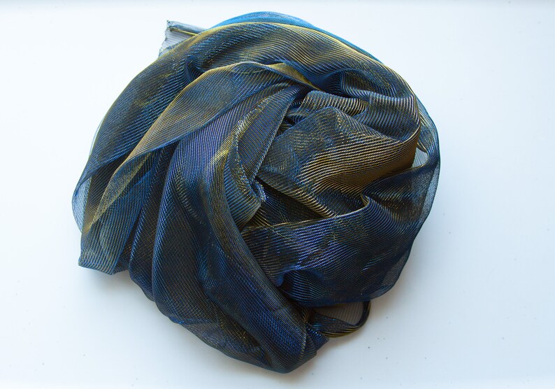 May include: A blue and gold metallic mesh fabric, crumpled and gathered into a ball.