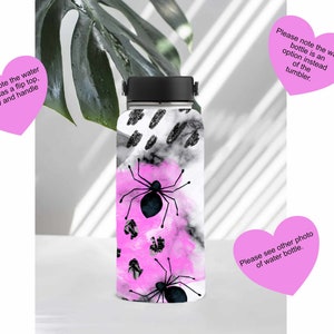 May include: A black and white water bottle with a pink and black spider design. The bottle has a flip top, straw, and handle. Please note the water bottle is an option instead of the tumbler.