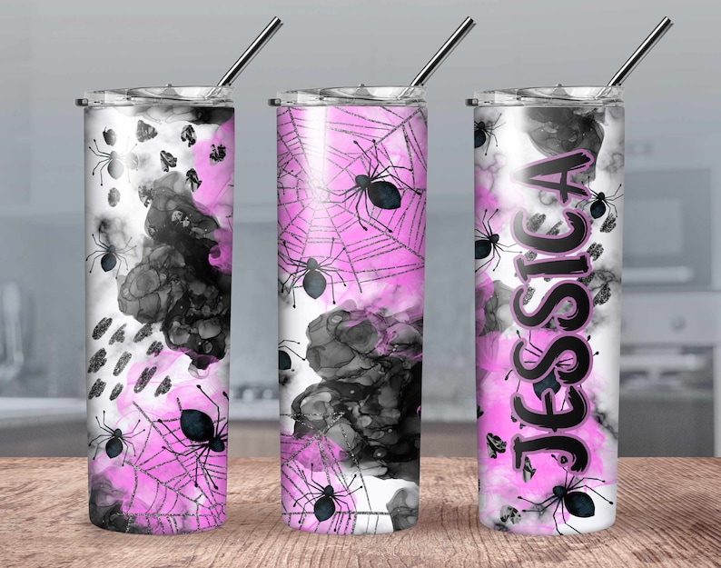 May include: Three stainless steel tumblers with a pink and black spiderweb design. The tumblers have a black and white abstract design with pink accents. One tumbler has the name "Jessica" written in black on the side.