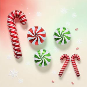 May include: A collection of foil balloons featuring one large red and white striped candy cane, two round peppermint candies in red and white and green and white, and two smaller red and white striped candy canes on a gradient background.