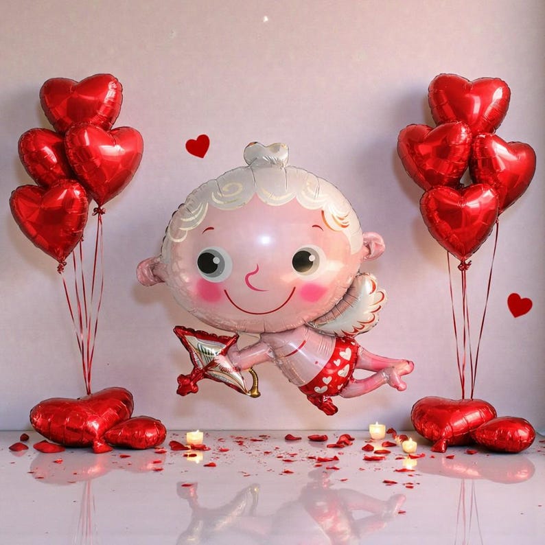 May include: A Valentine's Day scene featuring a large cupid-shaped balloon holding a bow and arrow, surrounded by red heart-shaped balloons. Scattered rose petals and small candles add to the romantic ambiance. The cupid balloon is pink and white.