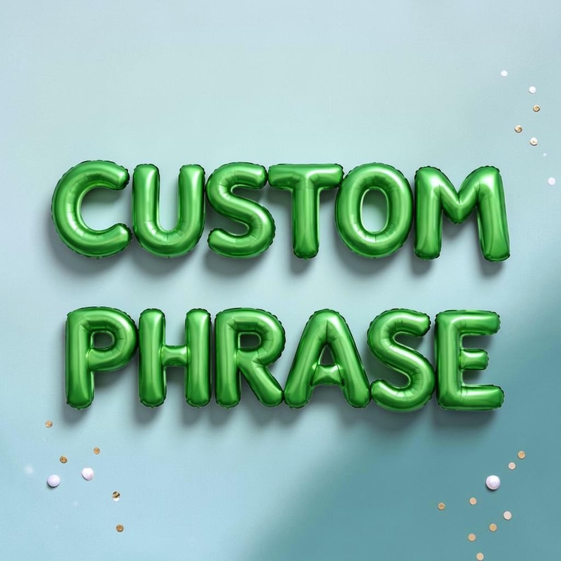 May include: Green foil balloon letters spelling "CUSTOM PHRASE" against a light blue background. The balloons are inflated and arranged in two rows. Scattered confetti adds a festive touch.