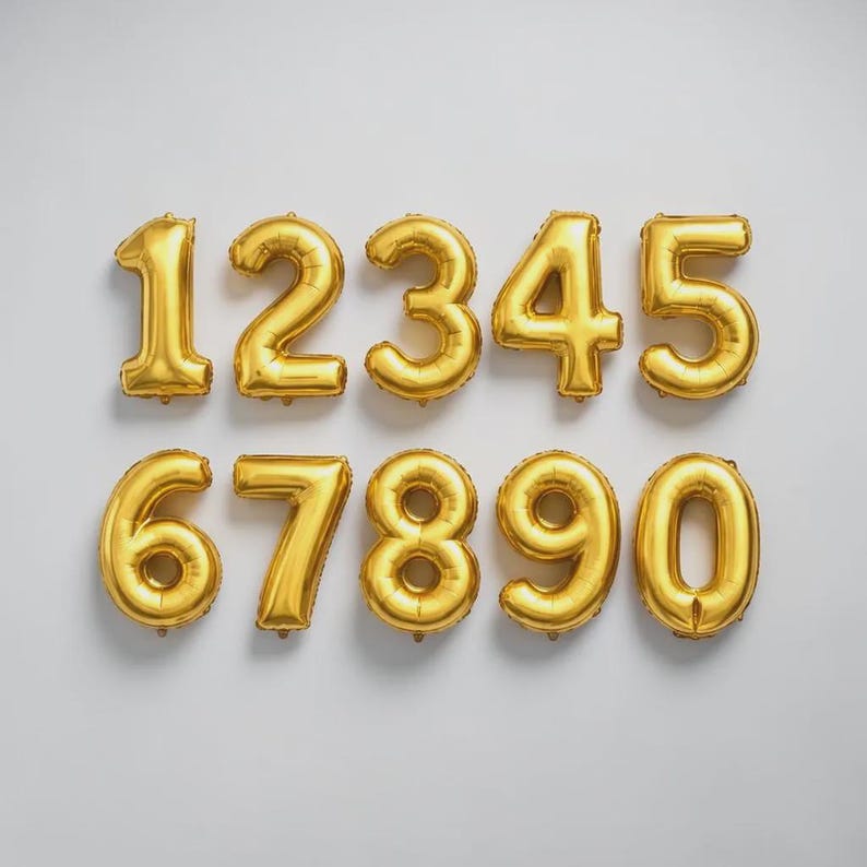 May include: Gold foil number balloons from zero to nine, arranged in two rows against a white background. The numbers are inflated and have a metallic sheen, perfect for birthday celebrations or anniversaries.