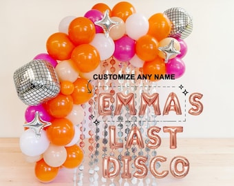 May include: A festive balloon arch in shades of orange, pink, white, and beige, with two disco ball balloons and star-shaped foil balloons. The phrase "EMMA'S LAST DISCO" is spelled out in rose gold foil balloons, with the text "CUSTOMIZE ANY NAME" above.