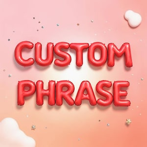 May include: Red balloon letters spelling "CUSTOM PHRASE" against a pink background. The balloons are inflated and arranged in two rows. Small star and confetti-like decorations are scattered around the letters, with a white cloud-shaped object in the corner.