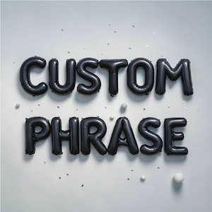 May include: Black foil balloons spelling out "CUSTOM PHRASE" against a white background. The balloons are arranged in two lines, with the word "CUSTOM" above "PHRASE". Small white spheres and confetti are scattered around the balloons.