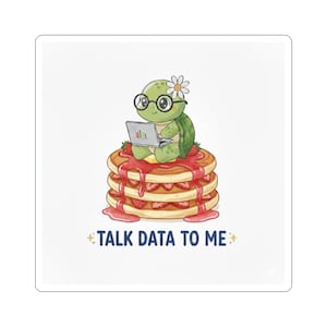 May include: A sticker featuring a cartoon turtle wearing glasses and a flower, sitting on a stack of pancakes with strawberries and syrup, working on a laptop. The text "TALK DATA TO ME" is below the pancakes.