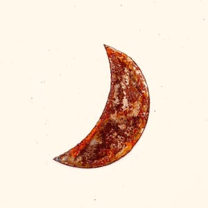 May include: A rusty metal crescent moon shape, isolated on a white background.