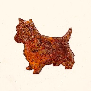 May include: A rusty metal silhouette of a dog, likely a Scottish Terrier, stands in profile. The dog's form is cut from metal with a textured, weathered appearance, showcasing shades of brown and orange.