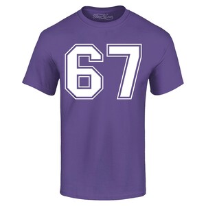 May include: A purple t-shirt with the number "67" in white block lettering. The number is outlined in white. The brand name "Shop4Ever" is printed in white on the upper right of the shirt.